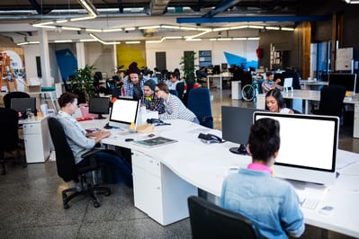 busy modern office with people working at desks